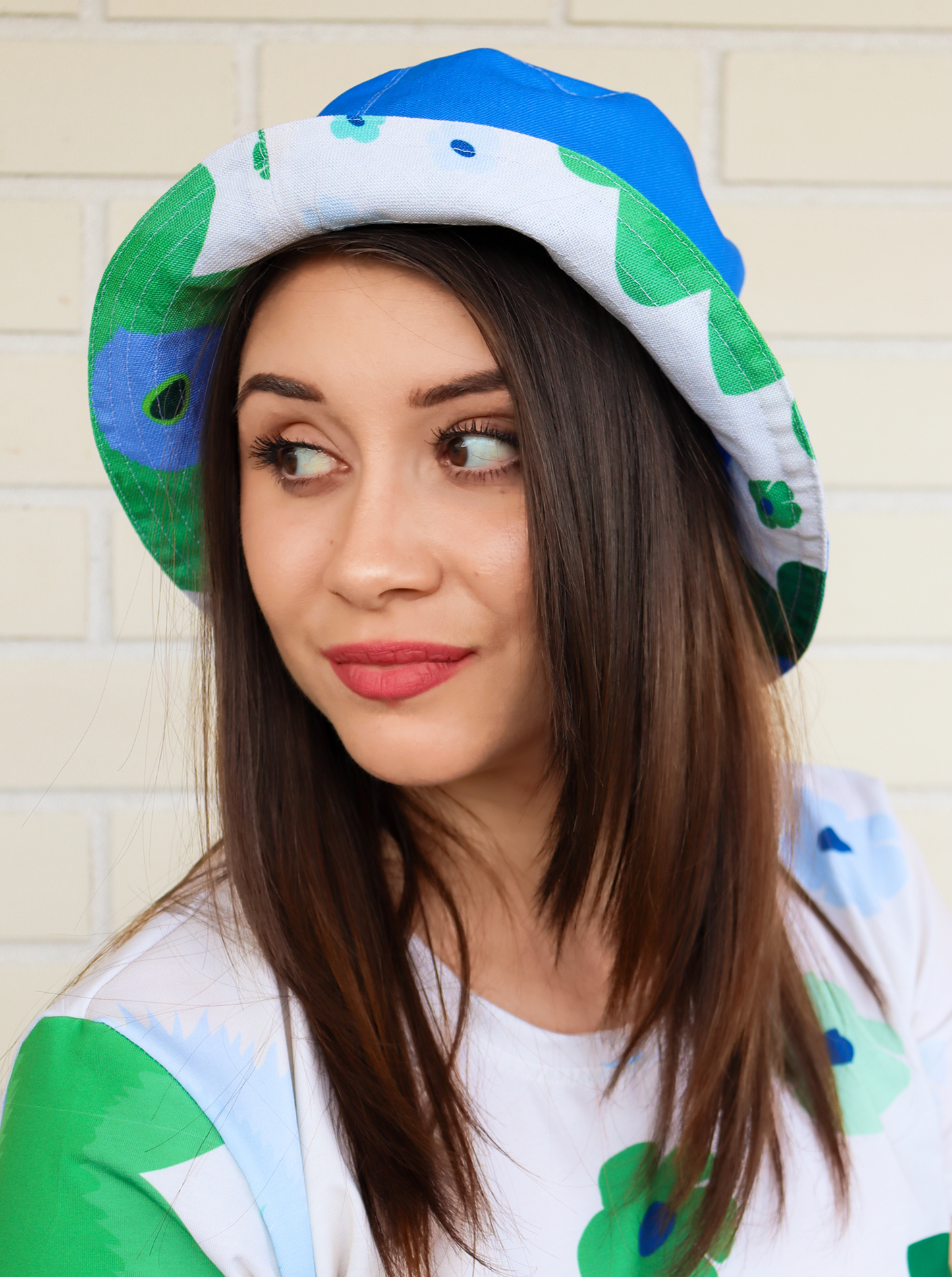 kevat / spring reversible two faced bucket hat inspired by the beauty of Finnish Summers, it is a bucket hat printed all over with a abstract floral pattern intones of green and fresh blue. Designed in Turku Finland by Print N Stuff